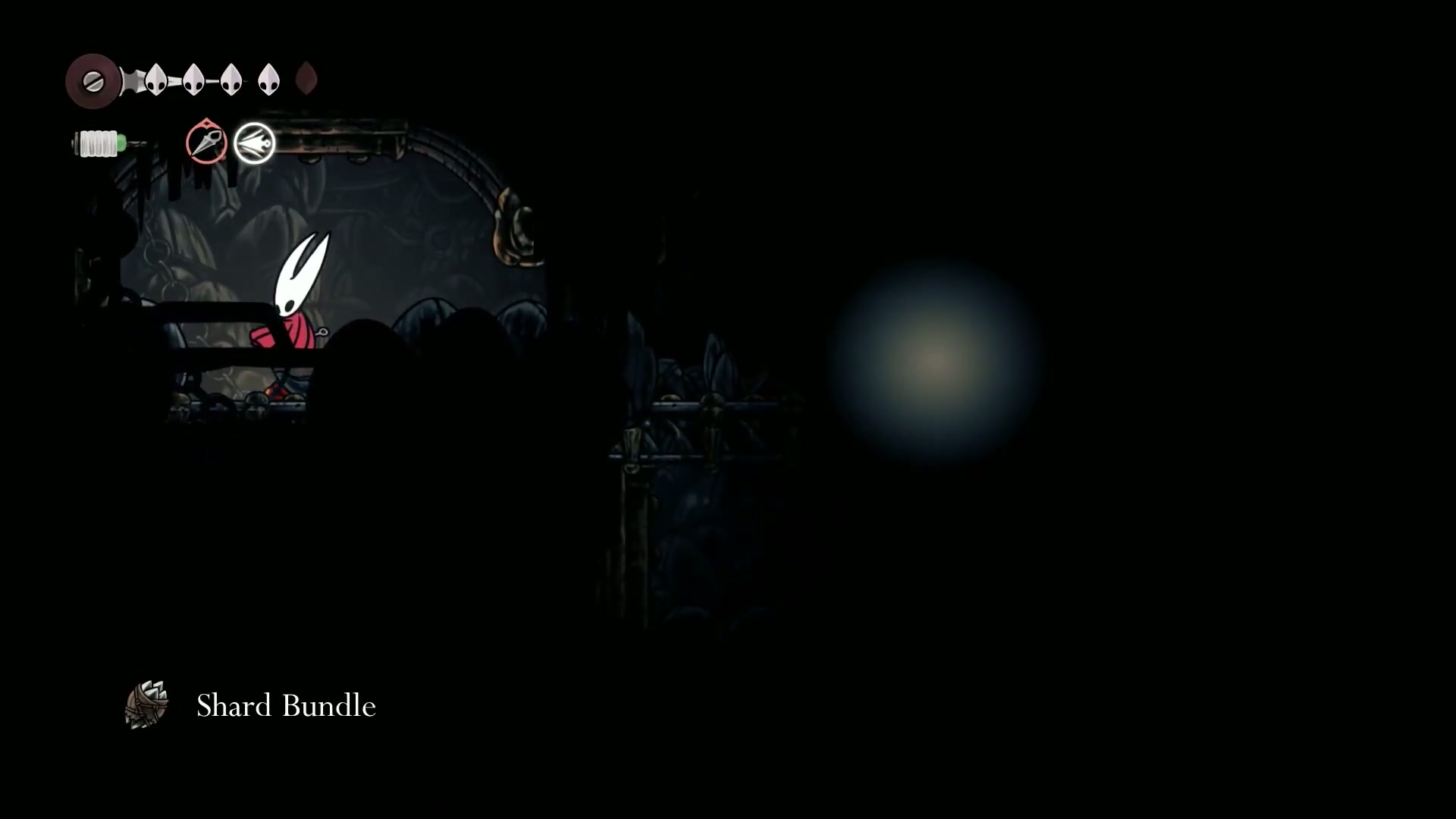 Hornet discovering a secret room containing a Shard Bundle in Deep Docks